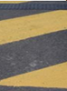 Road surface with painted yellow chevrons on it