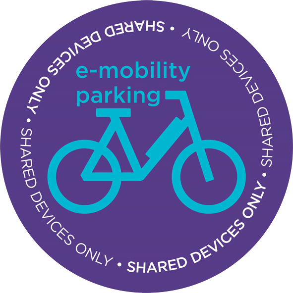 A purple circular sticker with an illustration of a bike, indicating where e-bikes can be parked on campus
