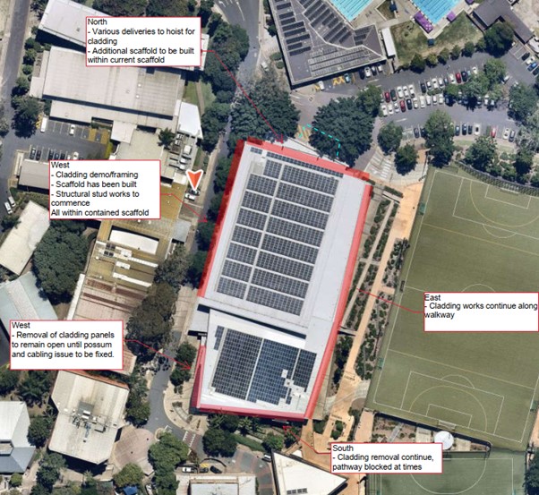 Aerial view of a building with solar panelsDescription automatically generated