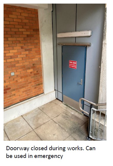 A blue door with a red sign on itDescription automatically generated