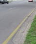 A street featuring a yellow line along the curb